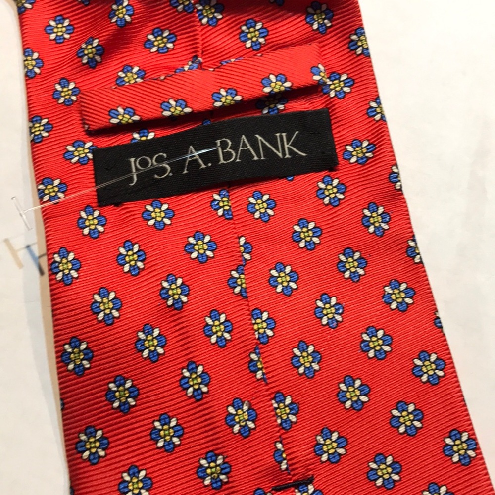 JOS A Bank tie mostly reddish in color
